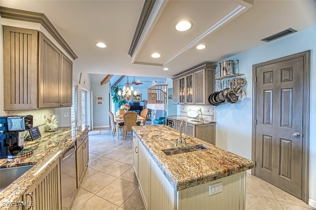 kitchen with a kitchen island with sink, sink, backsplash, and dishwasher