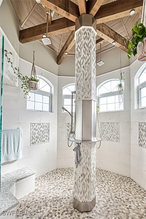 bathroom featuring lofted ceiling with beams, wooden ceiling, and tiled shower