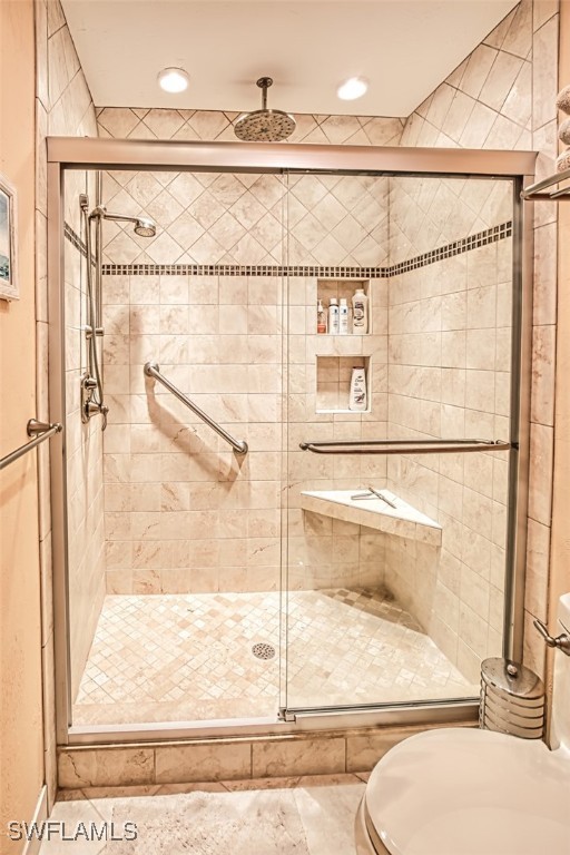 bathroom featuring a shower with door