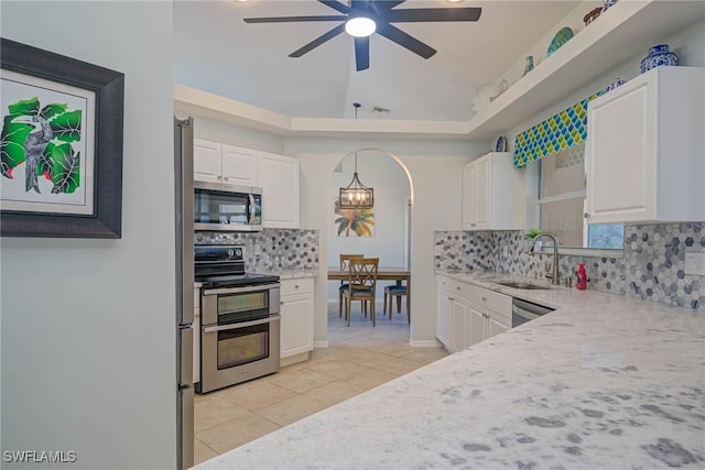 kitchen featuring appliances with stainless steel finishes, decorative light fixtures, sink, white cabinets, and light tile patterned floors