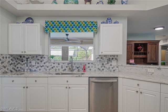 kitchen featuring white cabinetry, stainless steel dishwasher, and sink