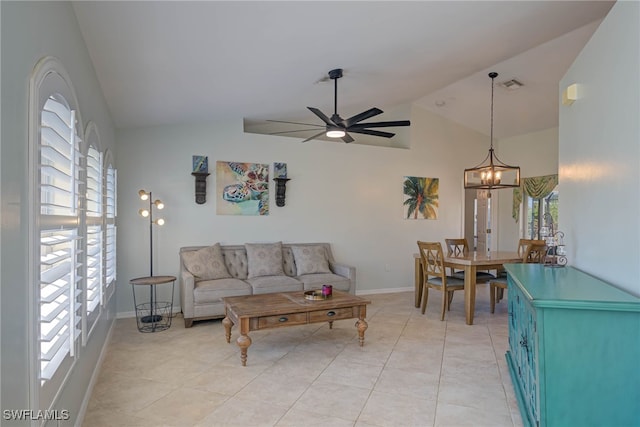 living room featuring light tile patterned floors, ceiling fan with notable chandelier, vaulted ceiling, and a healthy amount of sunlight