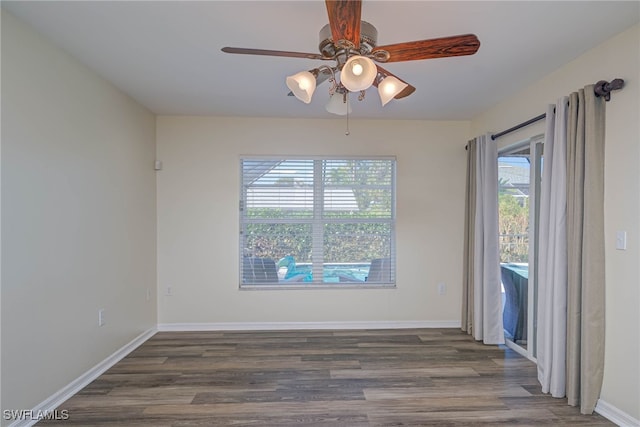 empty room with dark wood-type flooring and ceiling fan