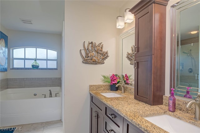 bathroom with vanity, a bathing tub, and tile patterned flooring