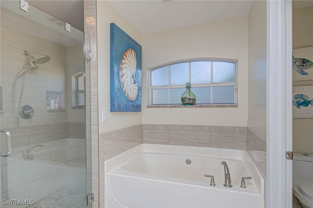 bathroom featuring toilet and shower with separate bathtub