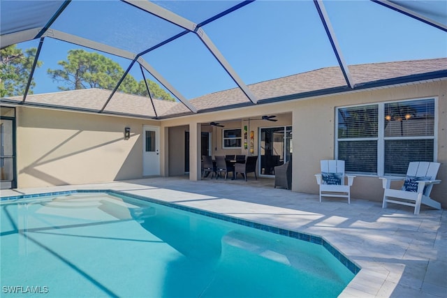 view of pool featuring a lanai, ceiling fan, and a patio area