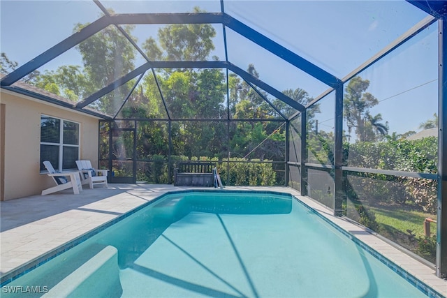 view of pool with a lanai and a patio