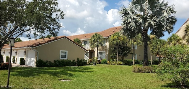 view of front of house featuring a garage and a front lawn