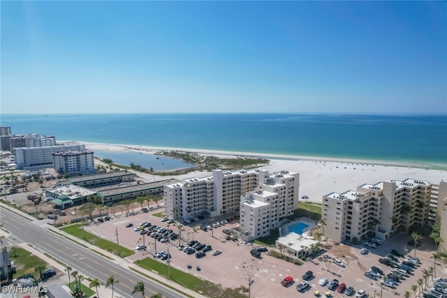 birds eye view of property with a water view and a view of the beach