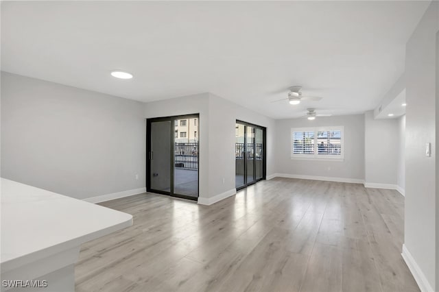 spare room featuring ceiling fan and light hardwood / wood-style floors