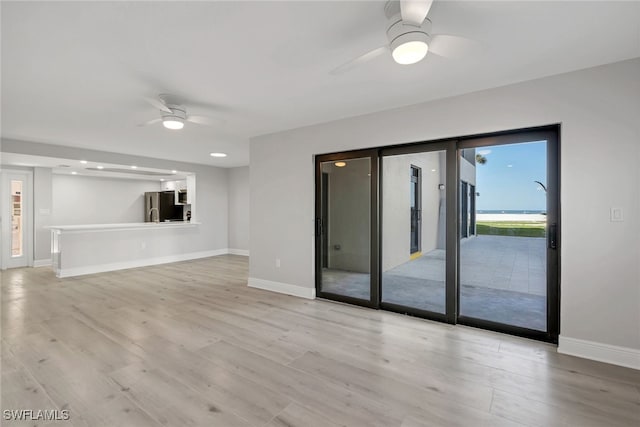 unfurnished living room featuring light hardwood / wood-style floors and ceiling fan