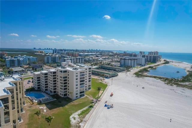 birds eye view of property featuring a beach view and a water view