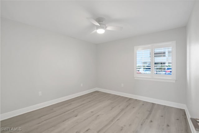 spare room with light hardwood / wood-style floors and ceiling fan