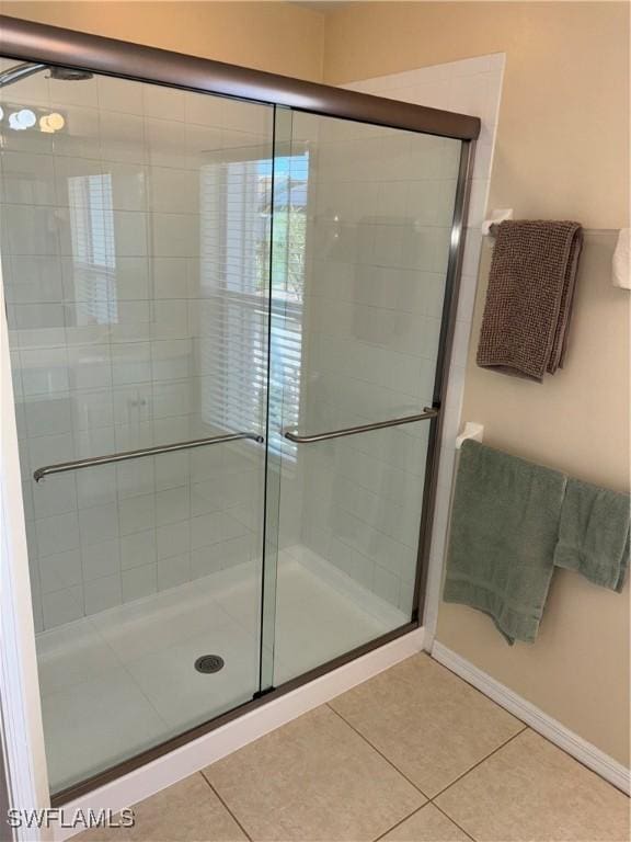 bathroom with tile patterned floors and walk in shower