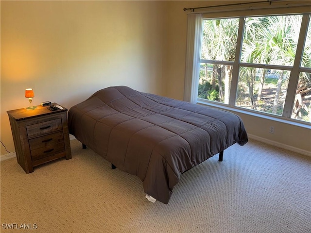 bedroom featuring light carpet