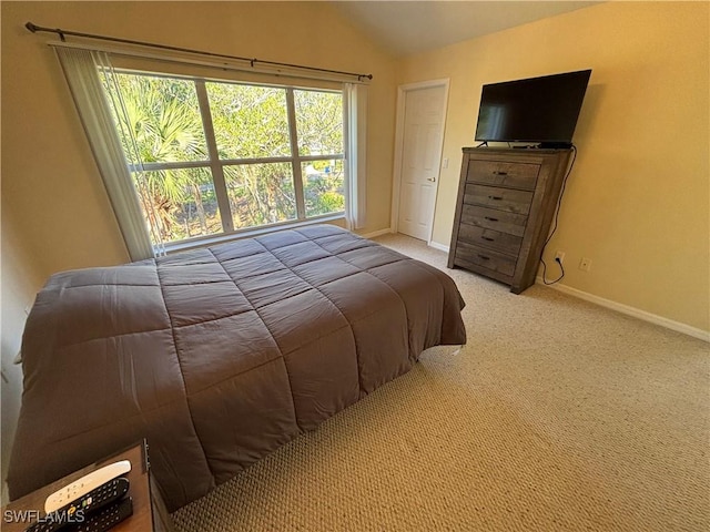 carpeted bedroom featuring vaulted ceiling