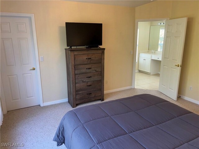 bedroom featuring light carpet and baseboards