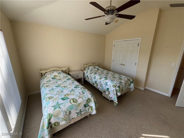 bedroom with ceiling fan, carpet flooring, vaulted ceiling, and a closet