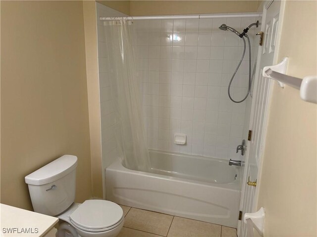 full bathroom with tile patterned flooring, shower / tub combo with curtain, toilet, and vanity