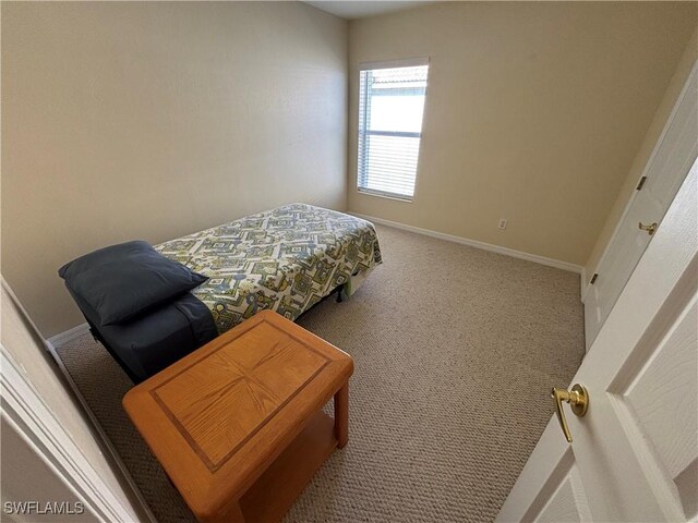 carpeted bedroom with baseboards