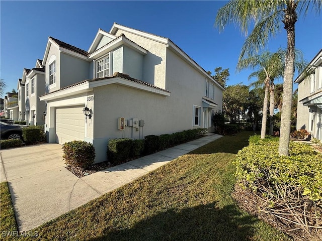 view of home's exterior with a yard and a garage