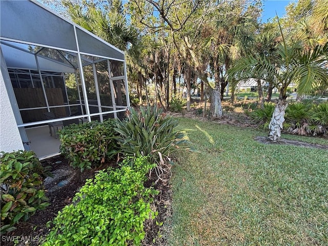 view of yard featuring glass enclosure