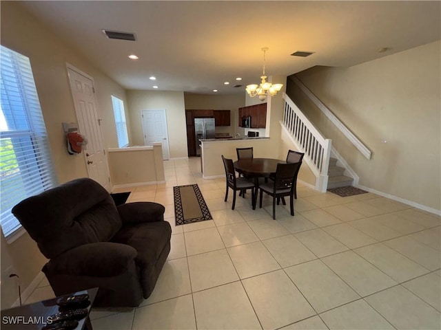 tiled dining area featuring a chandelier