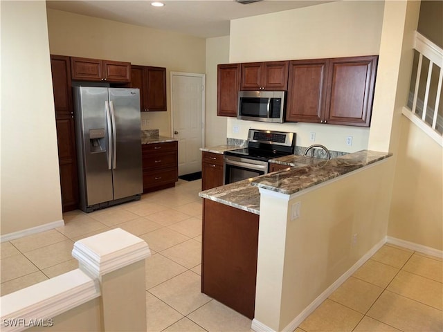 kitchen featuring light tile patterned floors, sink, appliances with stainless steel finishes, dark stone countertops, and kitchen peninsula