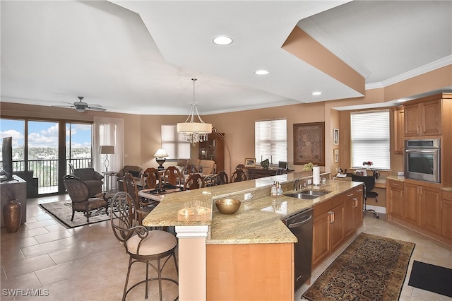 kitchen featuring appliances with stainless steel finishes, a large island, sink, and a breakfast bar area