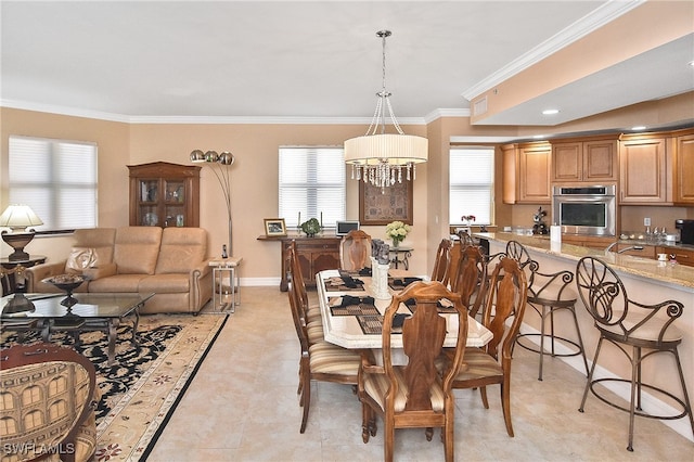 dining space featuring crown molding, a chandelier, and a wealth of natural light