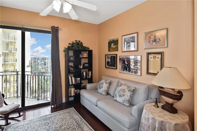 living room featuring dark hardwood / wood-style floors and ceiling fan