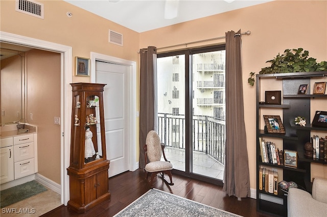 sitting room with dark hardwood / wood-style flooring