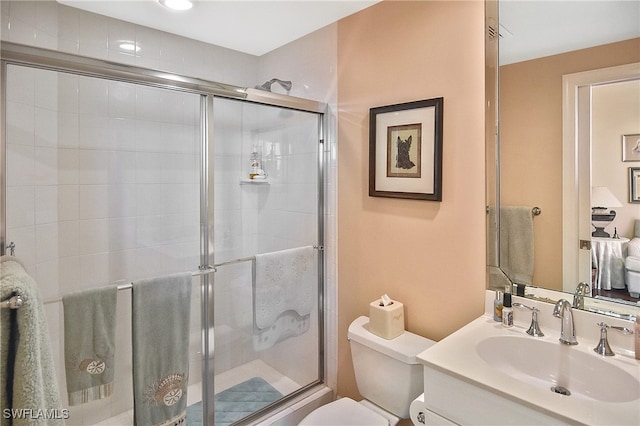 bathroom featuring vanity, toilet, and walk in shower