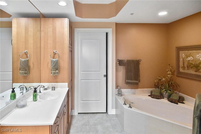 bathroom with vanity, tile patterned flooring, and a relaxing tiled tub