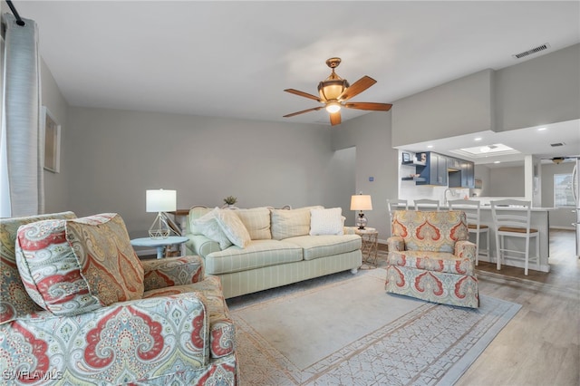 living room featuring light hardwood / wood-style floors and ceiling fan