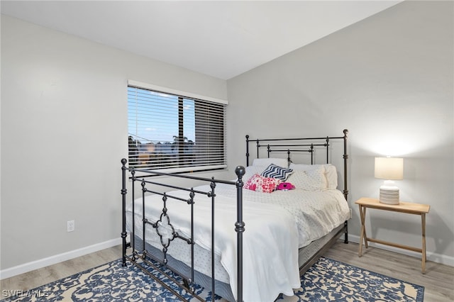 bedroom with hardwood / wood-style flooring