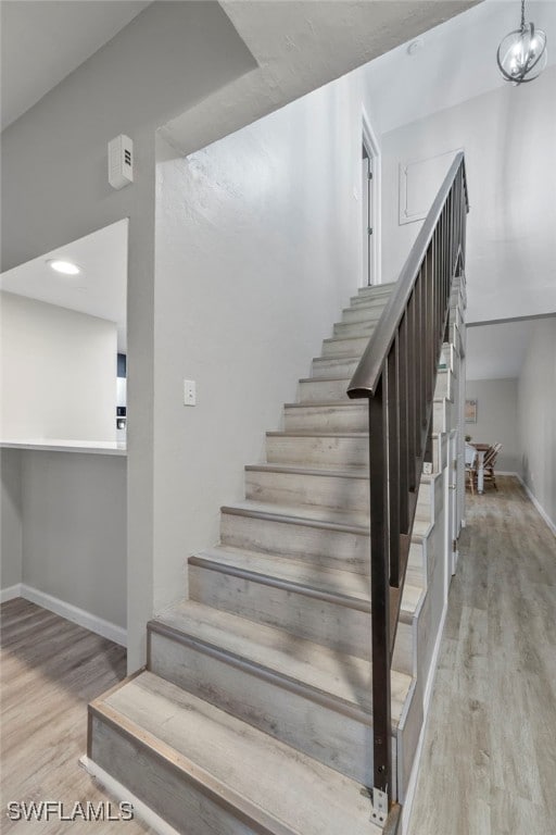 stairs featuring hardwood / wood-style flooring