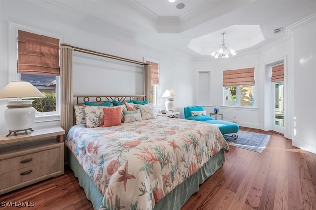 bedroom featuring an inviting chandelier, access to outside, ornamental molding, dark hardwood / wood-style flooring, and a raised ceiling