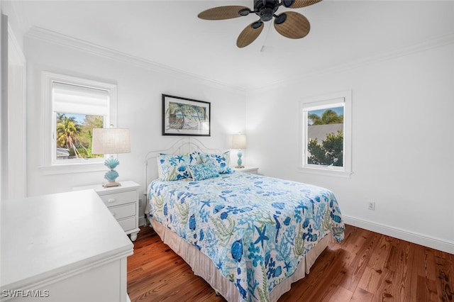 bedroom featuring hardwood / wood-style flooring, ceiling fan, and crown molding