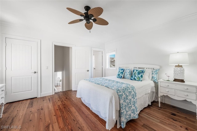 bedroom featuring hardwood / wood-style flooring, ornamental molding, and ceiling fan