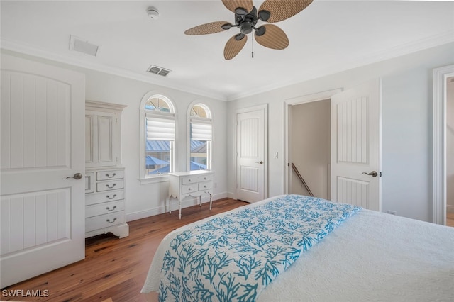 bedroom featuring crown molding, wood-type flooring, and ceiling fan