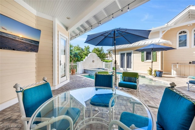 view of patio with a swimming pool with hot tub