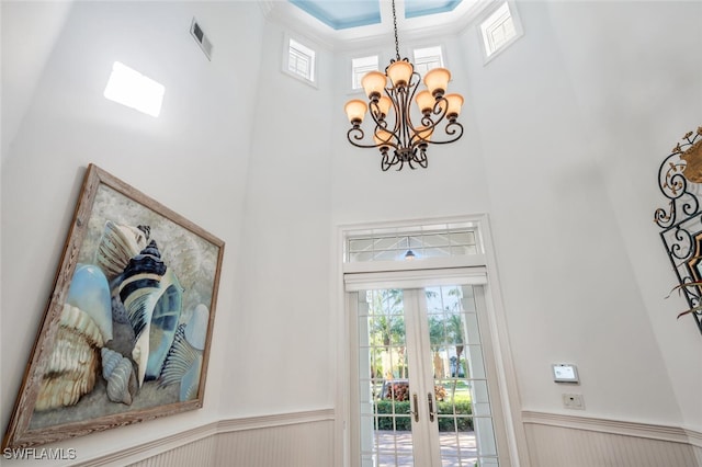 entrance foyer featuring an inviting chandelier and a high ceiling