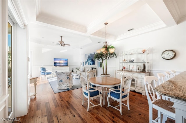 dining room featuring beamed ceiling, crown molding, ceiling fan with notable chandelier, and dark hardwood / wood-style flooring