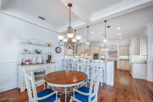 dining area with ornamental molding, dark hardwood / wood-style floors, a chandelier, and beam ceiling