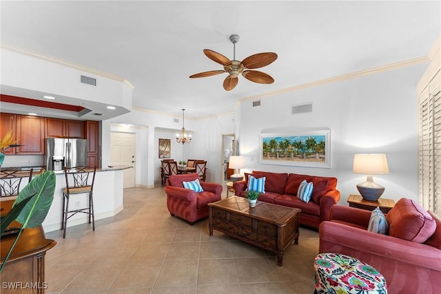 living room featuring light tile patterned flooring, ornamental molding, and ceiling fan with notable chandelier