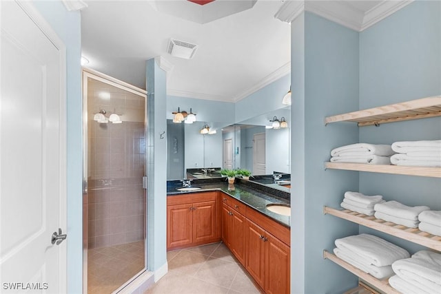 bathroom featuring crown molding, tile patterned floors, an enclosed shower, and vanity