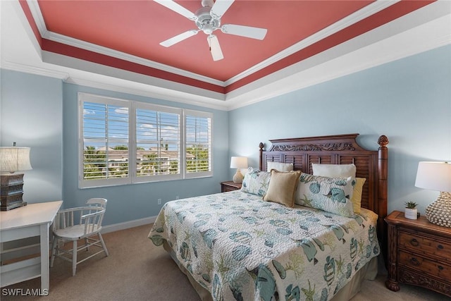 bedroom featuring ornamental molding, light colored carpet, a raised ceiling, and ceiling fan