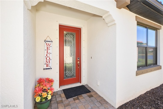 property entrance featuring stucco siding