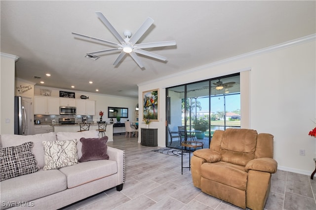 living room featuring ornamental molding and ceiling fan